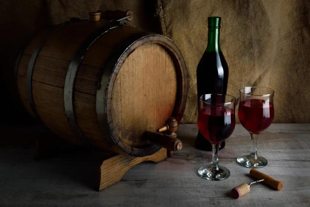 bottle-wine-with-glass-corkscrew-wooden-background