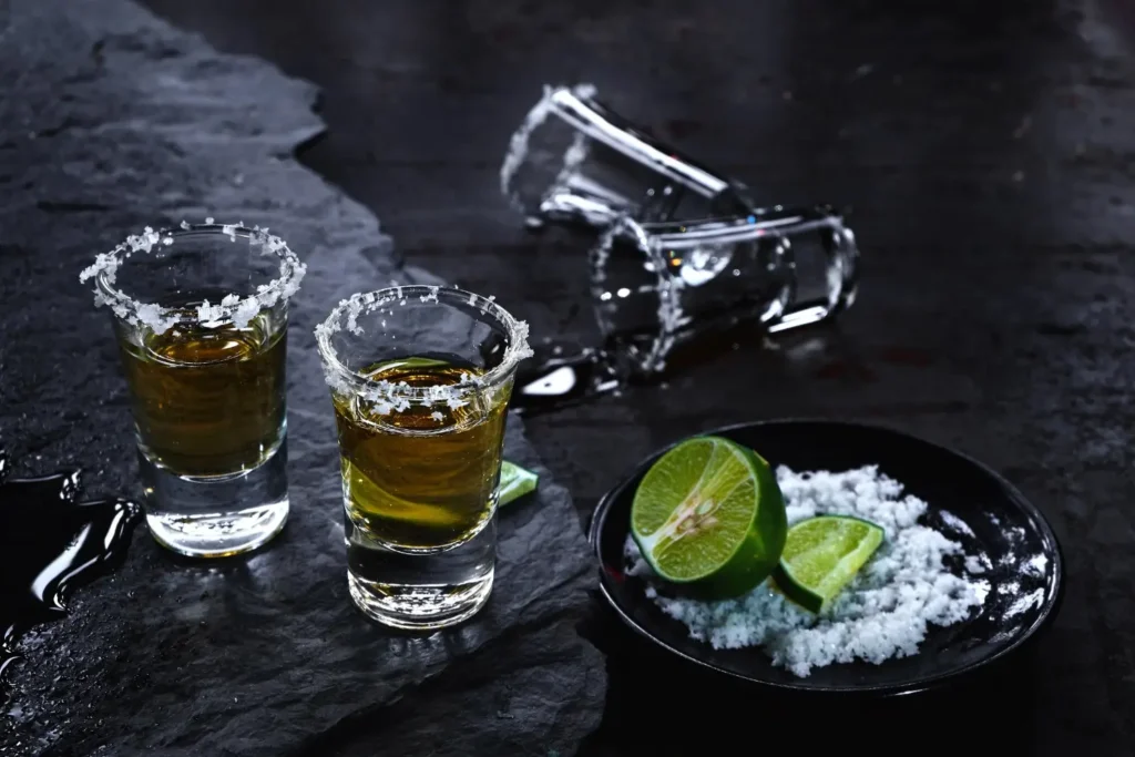 high-angle-view-vodka-shots-by-lime-salt-table