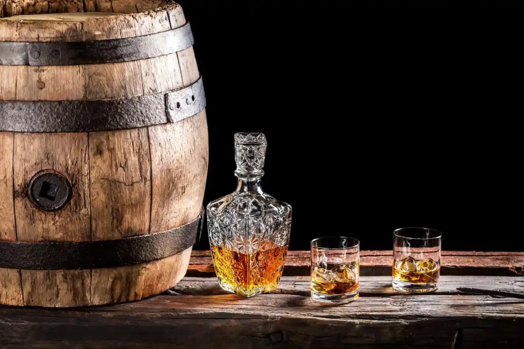 whiskey-barrel-decanter-glasses-rustic-on-wooden-surface